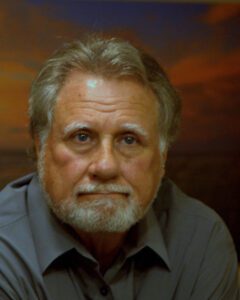 Picture of Rick the Author in a blue colored shirt against a sky background